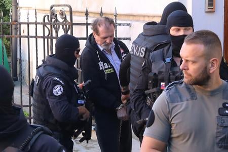 Juraj Cintula, charged with a terrorist attack on PM Robert Fico, arrives at the Specialised Criminal Court in Banská Bystrica on Tuesday, 5 August 2025, escorted by prison guards.