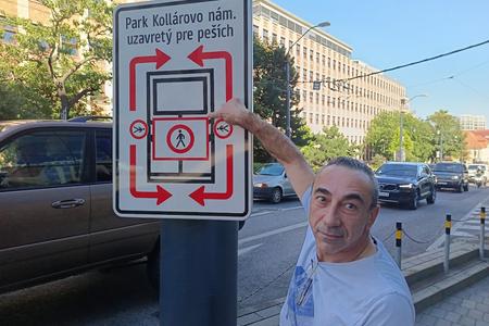 Renato Lamanna points to signage stating that the area outside his restaurant is closed.