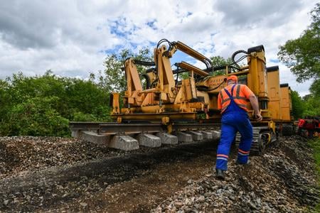 Track worker laying rail panels during maintenance on the Vaďovce–Stará Turá line in western Slovakia, May 2025.