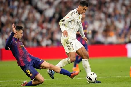 Na snímke hráč Barcelony Pedri (vľavo) a hráč Realu Madrid Jude Bellingham bojujú o loptu v zápase 10. kola španielskej La Ligy Real Madrid - FC Barcelona.