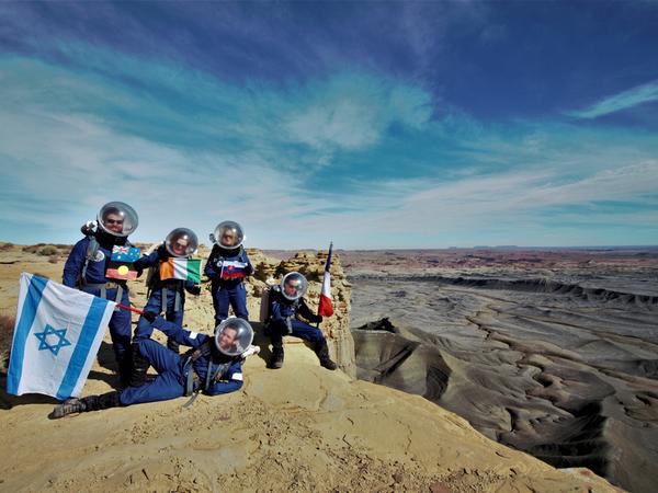 Mars Crew 173 on Mars with flags.