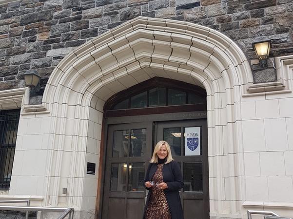 In front of the school where she teaches German.