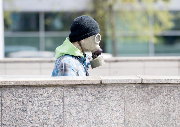 A man wearing a gas mask walks into an underpass on Hodžovo Square in Bratislava on April 14, 2020. 