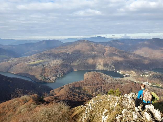 A hiker takes in the view from the rocky summit of Sivec, overlooking the Ružín Reservoir in the Košice-okolie district.
