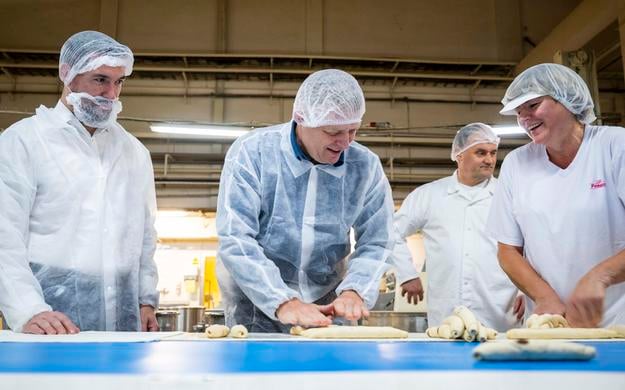 From left, Agriculture Minister Richard Takáč (Smer) and Prime Minister Robert Fico (Smer) visit the First Bratislava Bakery on 16 October 2024 in Bratislava, marking World Bread Day and the signing of a cooperation memorandum.