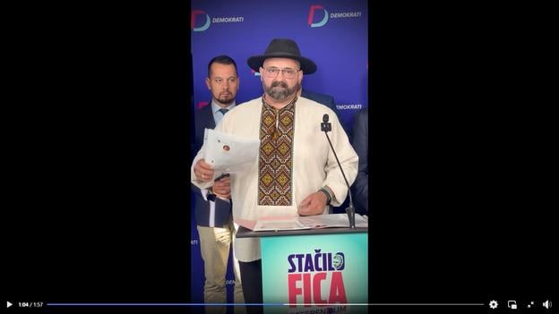 Activist Peter Laťák speaking at a Democrats party press conference.