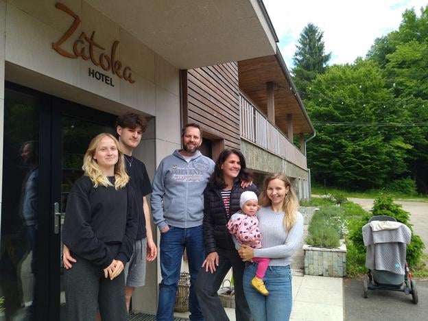 Andrea Falátová with her family outside the Zátoka Hotel on the shores of Domaša.
