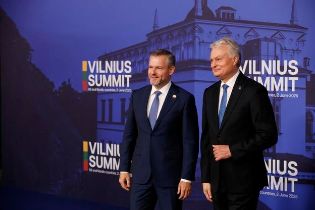 Lithuania's President Gitanas Nauseda, right, welcomes Slovakia's President Peter Pellegrini during arrivals for the Vilnius Summit at the Palace of the Grand Dukes of Lithuania in Vilnius, Lithuania, Monday, June 2, 2025.