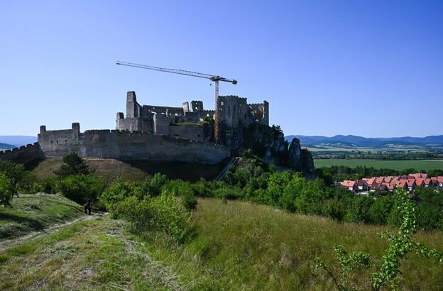 Beckov Castle and a tower crane on the lower courtyard during restoration works on the west wing of the northern palace in Beckov, Saturday, 14 June 2025.
