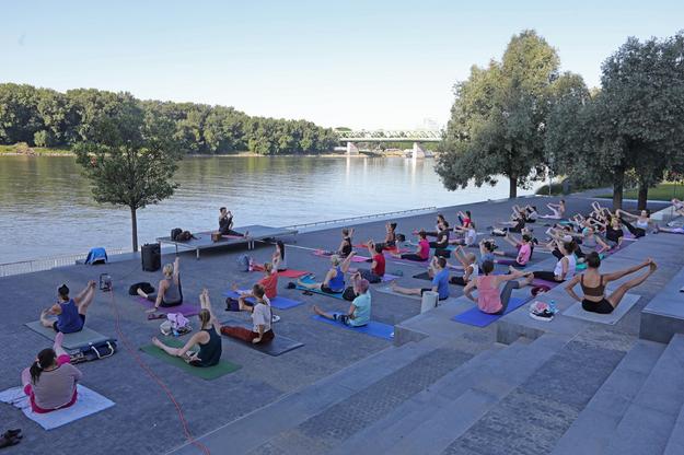 Outdoor yoga session by the Eurovea shopping centre in Bratislava