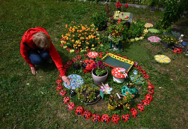 Elena Jakabová and her front garden – a mosaic of dry concrete, coloured glass and paint – outside a residential block in Myjava, Thursday 10 July 2025.