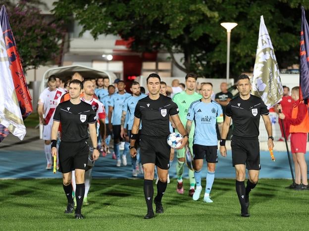 Players of Slovan Bratislava (in blue) and Zrinjski Mostar walk onto the pitch ahead of the second-leg UEFA Champions League second qualifying round match in Mostar on Tuesday, 29 July 2025. Slovan drew 2-2 away in Mostar after a 4-0 home win, securing progression and at least a spot in the group stage of the Europa Conference League. Slovan Bratislava advanced to the 2025/2026 Champions League third qualifying round, where they will face Kazakhstan’s Kairat Almaty.
