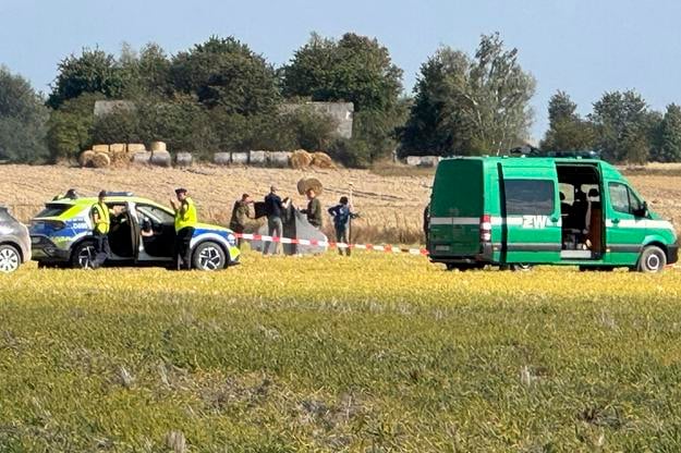 Police and Military Police secure parts of a damaged UAV shot down by Polish authorities  at a site in Wohyn, Poland, on 10 September 2025.
