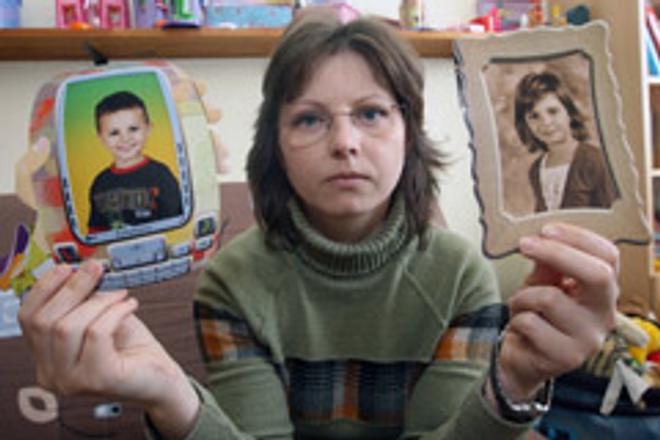 Daniela Hammoud shows pictures of her missing children, Husein and Fatima.