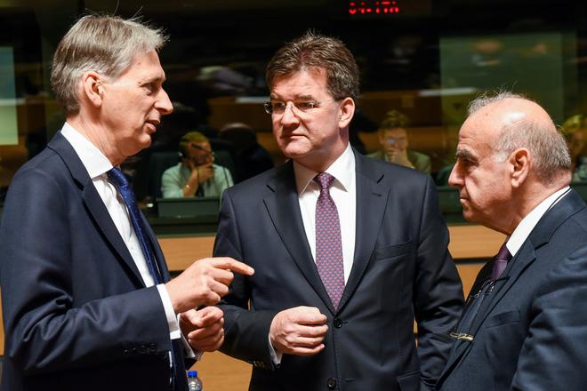 British Foreign Minister Philip Hammond, left, speaks with Slovakia's Foreign Minister Miroslav Lajčák, middle, and Malta's Foreign Minister George Vella during a meeting of EU foreign ministers at the EU Council building in Luxembourg, on June 20.