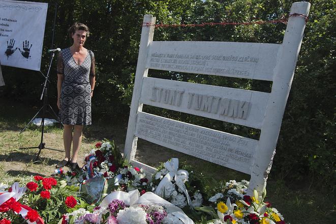 Carola Tautz, sister of Hartmut Tautz, standing at the memorial.