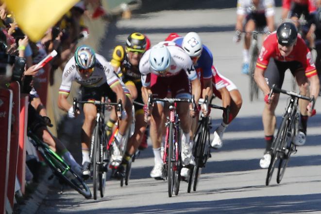 Peter Sagan, left, sprints as Britain's Mark Cavendish crashes, during the sprint of the fourth stage of the Tour de France cycling race.