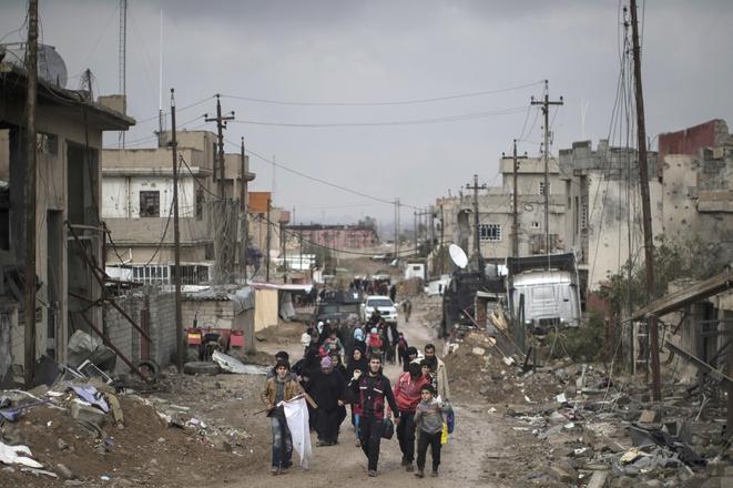 Iraqi civilians flee their homes during fighting between Iraqi security forces and Islamic State militants, on the western side of Mosul, Iraq, in March 2017.