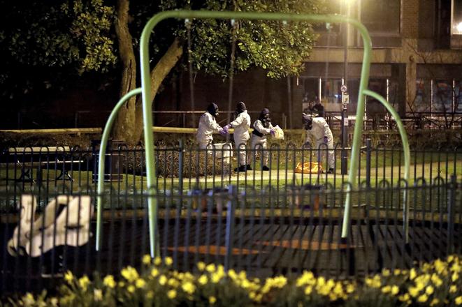 Investigators in protective suits work at the scene near the Maltings shopping centre in Salisbury, England, on Tuesday, March 13.