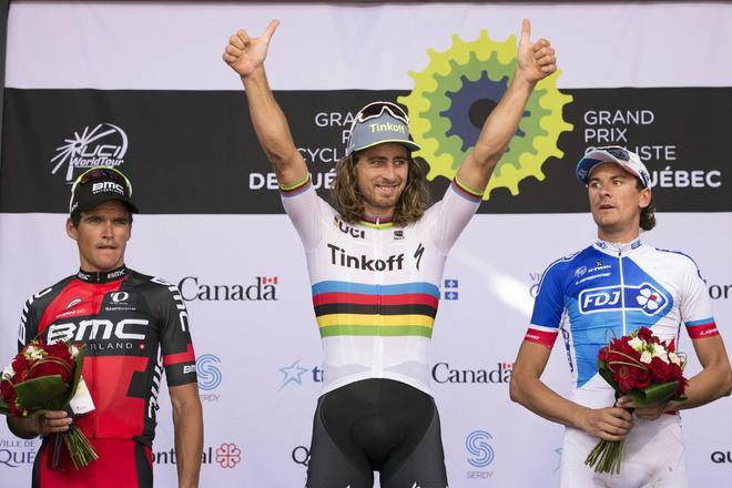 Peter Sagan, center, of Slovakia, raises his hands as he celebrates his win at the UCI Pro Tour cycling Grand Prix in Quebec City in September 2016.