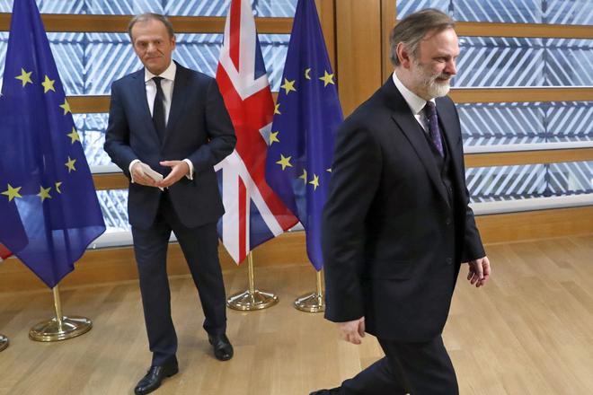 Britain's permanent representative to the European Union Tim Barrow (right) leaves after he delivered the Brexit letter to EU Council President Donald Tusk in Brussels.