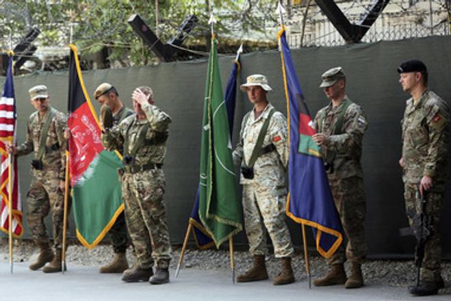 Afghanistan and NATO soldiers hold their flags before the start of the change of command ceremony at Resolute Support headquarters, in Kabul, Afghanistan, Sunday, September 2, 2018