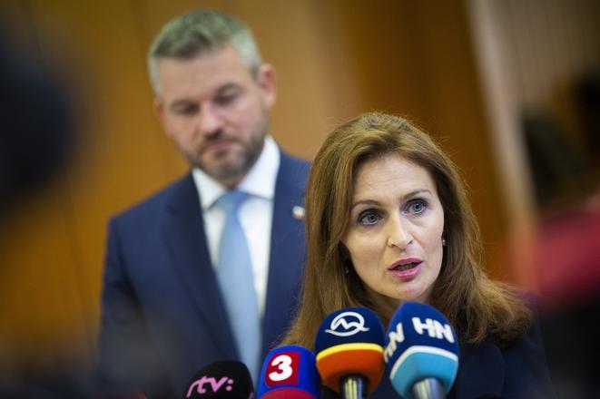 Health Minister Andrea Kalavská talks to the media after the government's meeting on September 27, 2019. PM Peter Pellegrini stands in the background