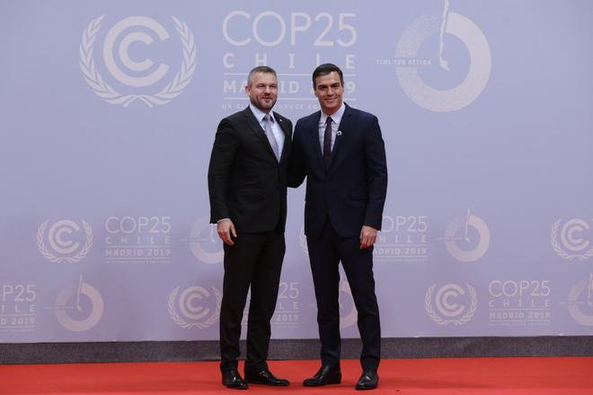 Spain's Prime Minister Pedro Sanchez and Slovakia's Prime Minister Peter Pellegrini shake hands at the COP25 climate talks summit in Madrid, Monday Dec. 2, 2019. The chair of a two-week climate summit attended by nearly 200 countries warned at its opening Monday that those refusing to adjust to the planet's rising temperatures "will be on the wrong side of history." 