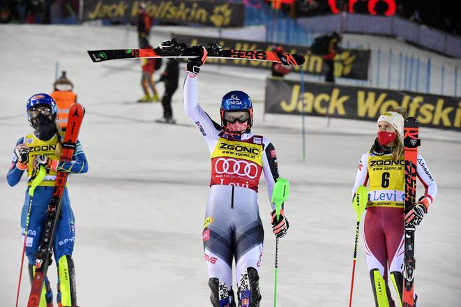 Petra Vlhová of Slovakia (centre), flanked by second placed Mikaela Shiffrin of the United States (l) and third placed Katharina Liensberger of Austria, celebrates after winning the alpine ski, women's World Cup slalom in Levi, Finland.