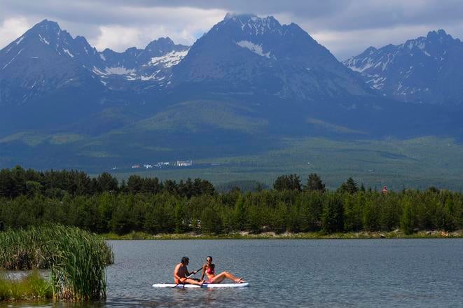 The panorama of the High Tatras and the gravel lake between the town of Svit and the village of Batizovce in the Poprad district. 