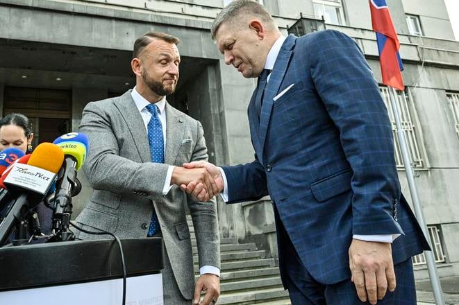 Interior Minister Matúš Šutaj Eštok and PM Robert fico shake hands outside the Interior Ministry in Bratislava on October 30, 2023.