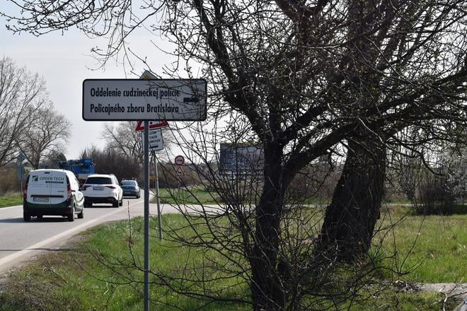 A road sign points towards the Foreigners' Police building in Bratislava.