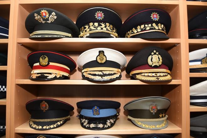 A collection of police, firefighter, military and naval caps.
