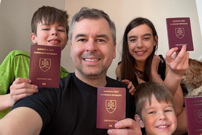 Jonathan Lukca with his three children, proudly holding their Slovak passports after reclaiming citizenship.