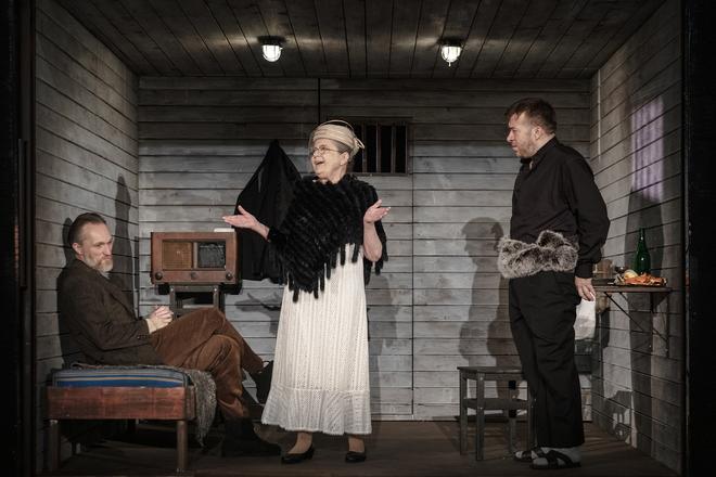 Marián Mitaš as Alfréd Wetzler, Zuzana Kronerová as Eugénia Propperová and Martin Madej as president Jozef Tiso, with the boa around his hips in the Hitler's President play.