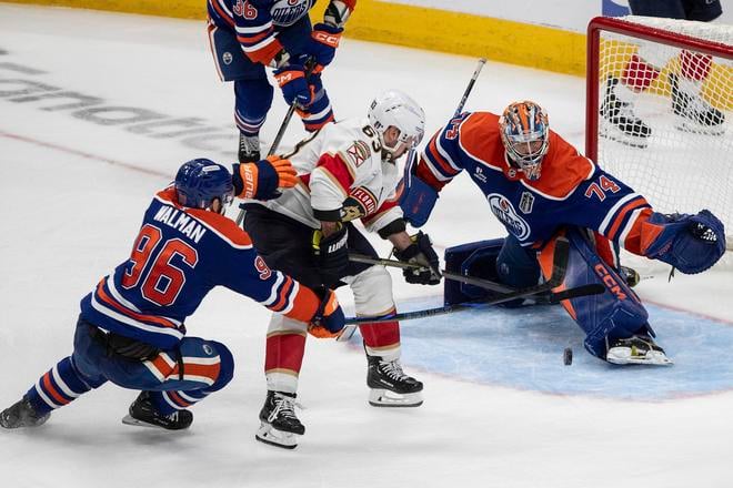 Brad Marchand (63) z Floridy Panthers je zastavený brankárom Edmontonu Oilers Stuartom Skinnerom (74).