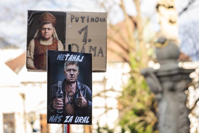 A poster reads: "Putin's First Lady."