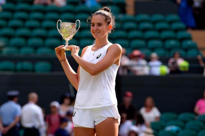 Mia Pohánková celebrates with the trophy after beating Julieta Pareja of the U.S. to win the final of the girls singles at the Wimbledon Tennis Championships in London, Saturday, 12 July 2025.