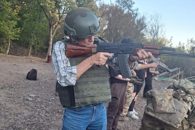 Former Slovak prime minister Ján Čarnogurský firing a submachine gun.