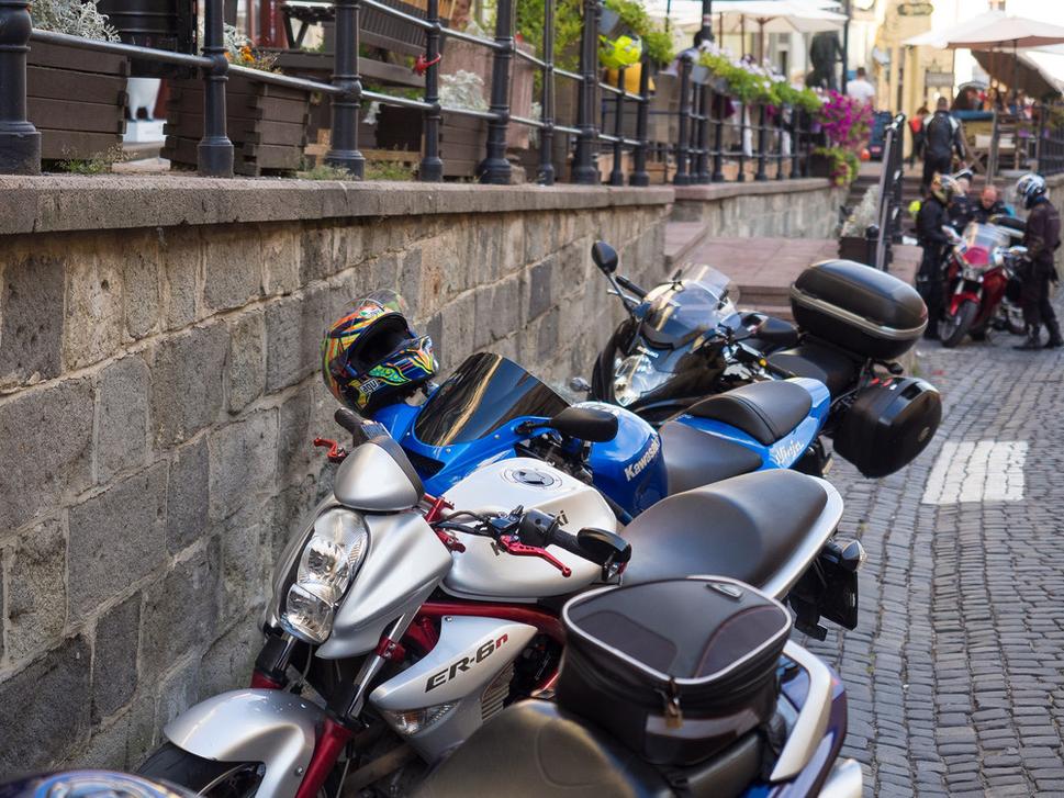 Motorky v Štiavnici parkujú doslova dva metre od kaviarenských stolíkov, ktoré sú priamo na ulici, po ktorej jazdia ďalšie stovky motoriek. Príjemné posedenie, že?