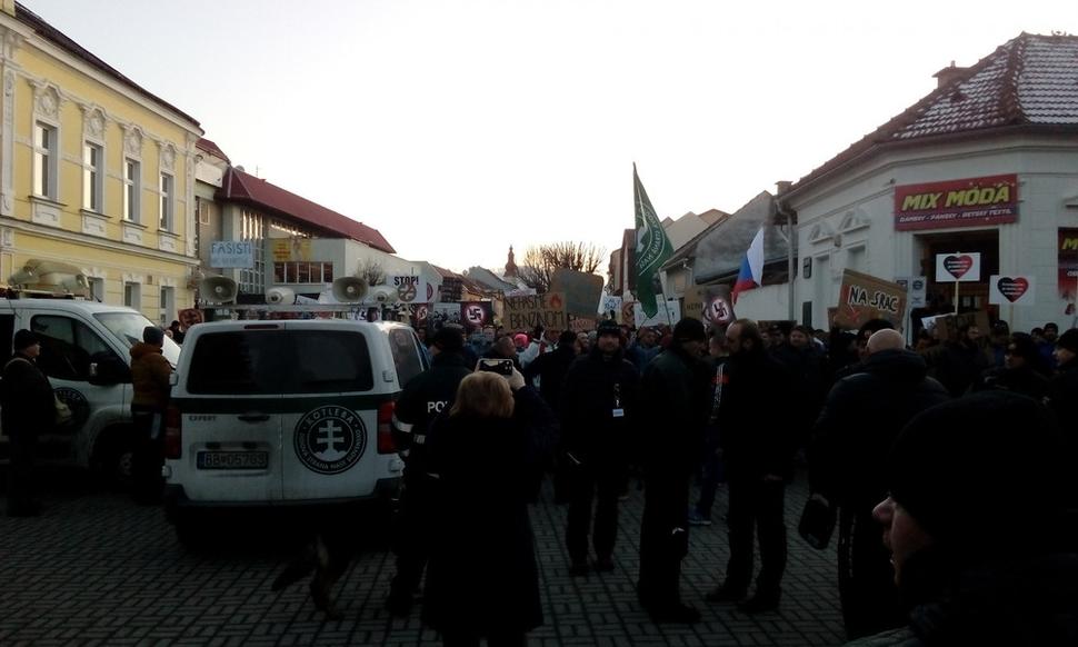 Dodávky zaparkované pred protestujcimi na námestí v Kysuckom Novom Meste.