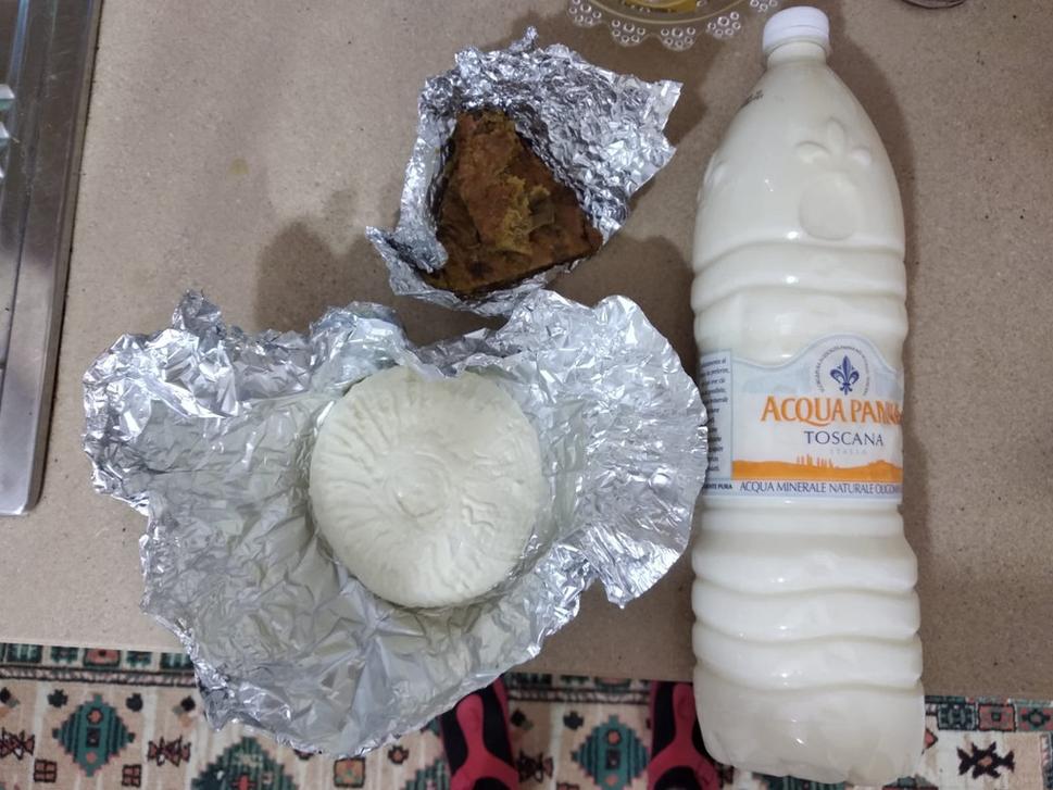 Fresh salty cheese and fresh milk to be boiled ahead the consumption. Received from the owner of my apartment, who lives on the right side of my house. While the other delicious thing wrapped in the silver paper was qofte with spinach, received from my neighbour living on the left side of my apartment.