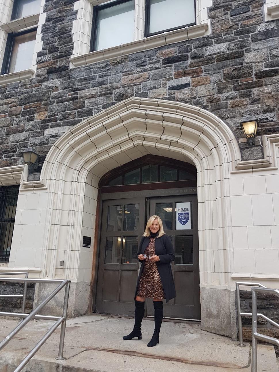 In front of the school where she teaches German.