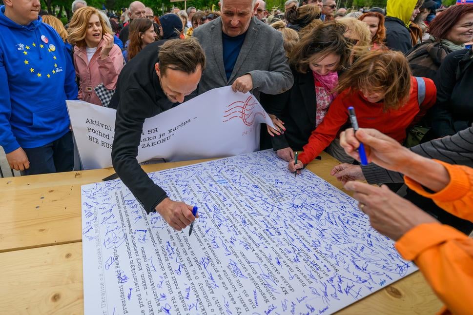 Protesters sign the open letter to Slovak President Peter Pellegrini.